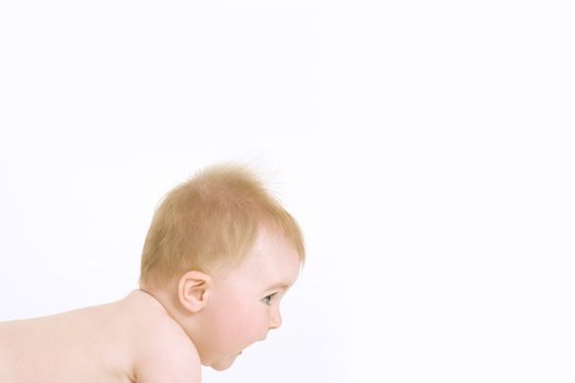 Side view of cute baby crawling on white background