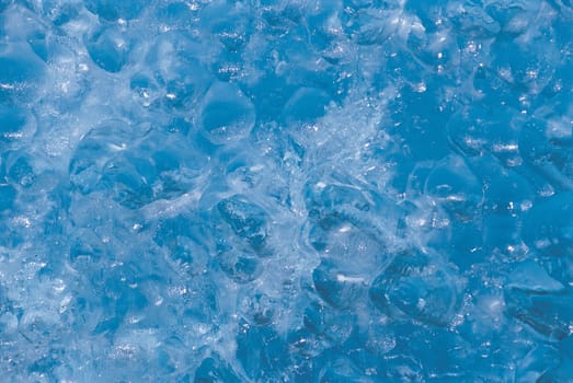 Closeup of water bubbling under ice