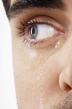 Detailed image of man's eye with tears isolated on white background