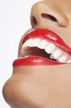 Detailed image of happy woman wearing red lipstick on white background