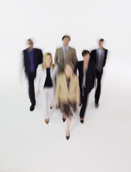 Group of businesspeople walking blurred effect