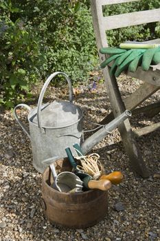 Closeup of gardening tools and chair in the garden