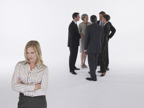 Executives in group with businesswoman left out