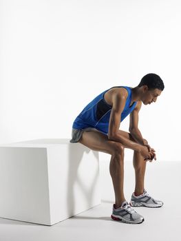 Athlete sitting on box side view