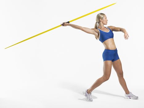 Female athlete preparing to throw javelin side view