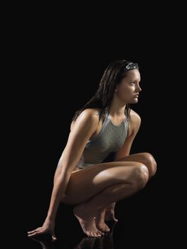 Female swimmer crouching side view