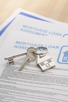 Keys to a New Home and mortgage papers on table