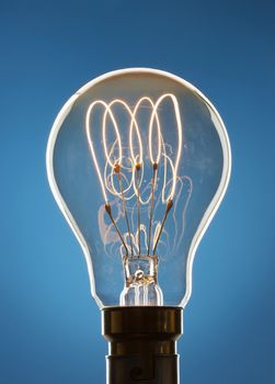 Transparent light bulb over blue background