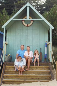 Portrait of a vacationing Family sitting together in beach hut