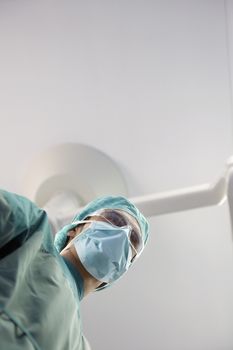 Low angle view of a surgeon in operating theatre