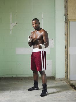 Full length portrait of a shirtless African American boxer