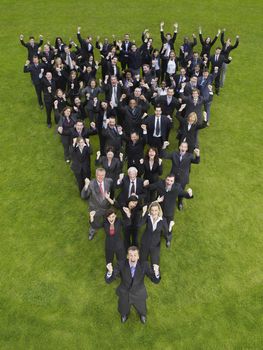 Large group of business people standing in triangle formation cheering elevated view