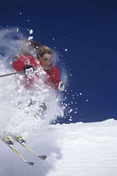 Skier skiing through powdery snow on ski Slope