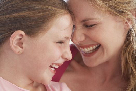 Closeup of mother and daughter laughing together