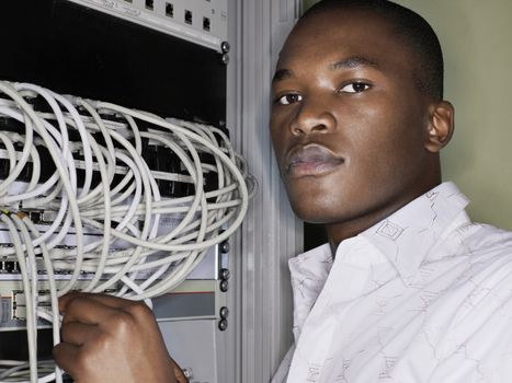 Portrait of network engineer working in server room