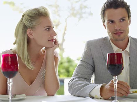 Beautiful young woman admiring man at dinner table