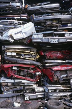 Pile of crushed cars in junkyard full frame