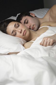 Young couple fast asleep in bed