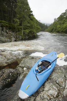 Blue kayak by river