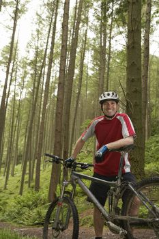 Male cyclist in forest portrait