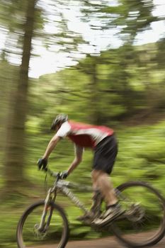 Male cyclist on track in countryside