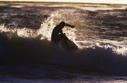 Man surfing wave silhouette
