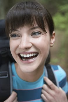 Woman wearing backpack smiling close-up