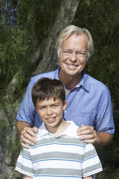 Portrait of a smiling grandfather with boy outdoors