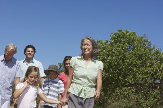 Three-generation family with two children (6-11) walking outdoors