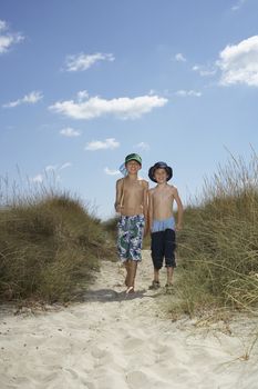 Boys With Fishing Net Walking On Sand Dunes