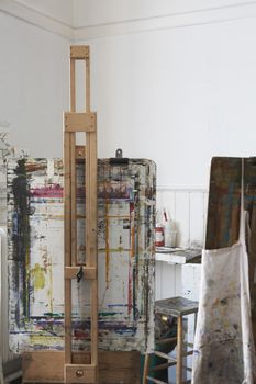Still life of paint splattered easels in art studio