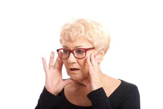 An old lady expresses shock/ surprise. 