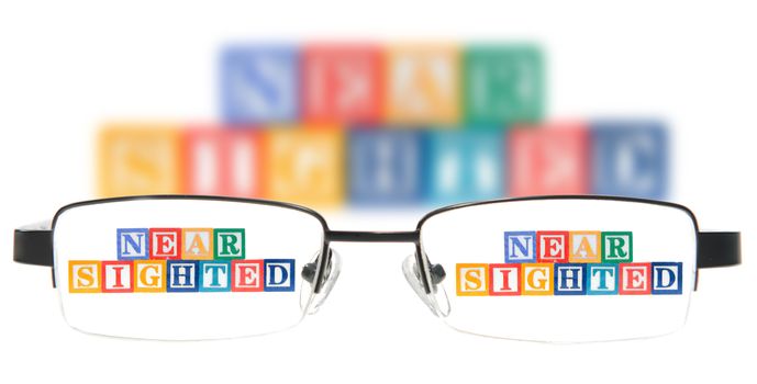 Letter blocks spelling near sighted with a pair of glasses.