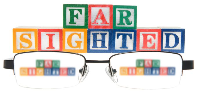 Letter blocks spelling far sighted with a pair of glasses