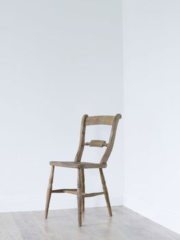 Wooden chair in empty room corner