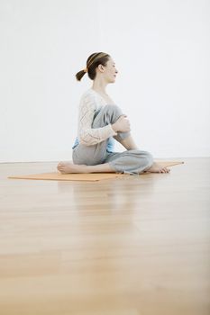 Teenage girl (16-17) performing yoga