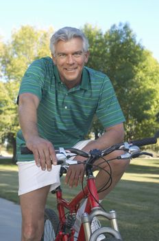 Portrait of a happy Caucasian man with bicycle