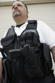 Low angle view of a security guard in bulletproof vest