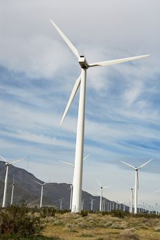 Power generation wind farm against cloudy sky