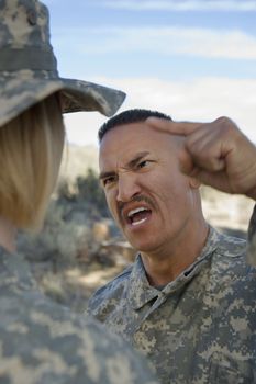 Military officer yelling at female soldier during a training session