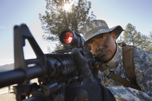 US army soldier aiming with rifle on a mission