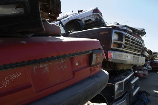 Obsolete cars piled up in a junkyard