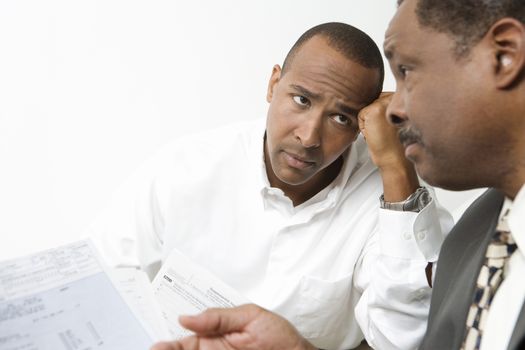 An African American businessmen worried over financial expenses