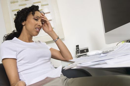 An African American worried woman doing finances
