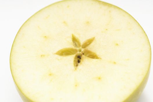 Cross section of a sliced granny smith apple isolated over white background