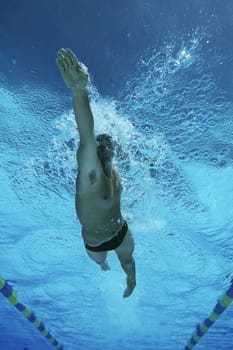 Low angle view of a male professional swimmer in pool