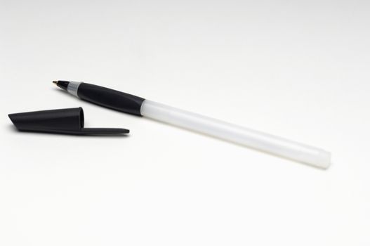Closeup of ballpoint pen with cap isolated over white background