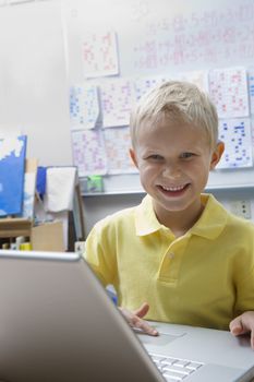 Schoolboy Using a Laptop