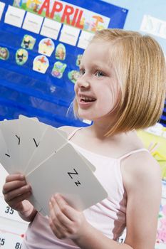 Elementary Student with Alphabet Flash Cards