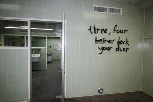 Graffiti on empty shower room wall in hospital